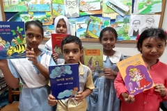 Students-showing-story-books-donated-by-Advisor-of-CWFD-Mufaweza-Khan